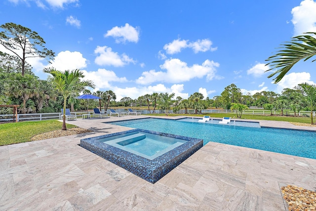 view of pool featuring a patio area, a pool with connected hot tub, and fence