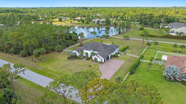 drone / aerial view with a view of trees and a water view