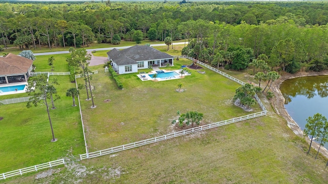 drone / aerial view featuring a water view and a forest view