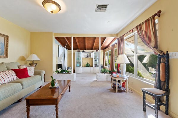 living room with visible vents, baseboards, and carpet