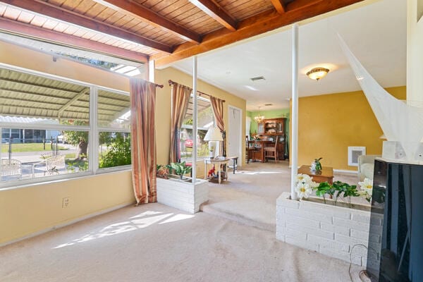 interior space with visible vents and beam ceiling