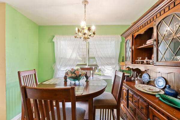 dining room featuring baseboards and an inviting chandelier