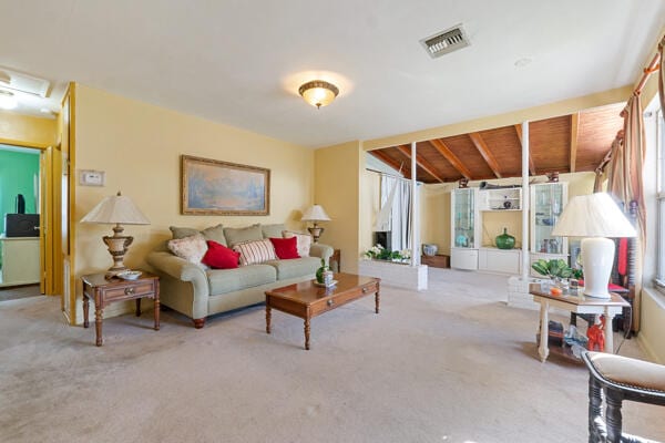 living area with visible vents and carpet floors
