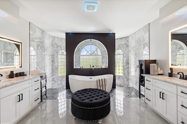 19361 W Sycamore Dr, The Acreage, FL 33470 - bathroom featuring a soaking tub, two vanities, marble finish floor, a sink, and walk in shower