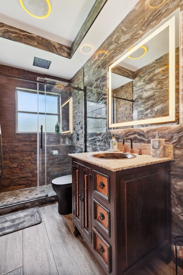 19361 W Sycamore Dr, The Acreage, FL 33470 - full bath with vanity, toilet, a shower stall, visible vents, and wood finished floors