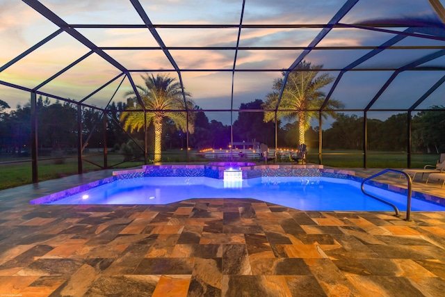 19361 W Sycamore Dr, The Acreage, FL 33470 - pool at dusk featuring a patio area, glass enclosure, and an outdoor pool