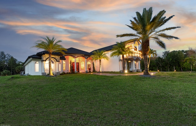 19361 W Sycamore Dr, The Acreage, FL 33470 - mediterranean / spanish home featuring stucco siding and a front lawn