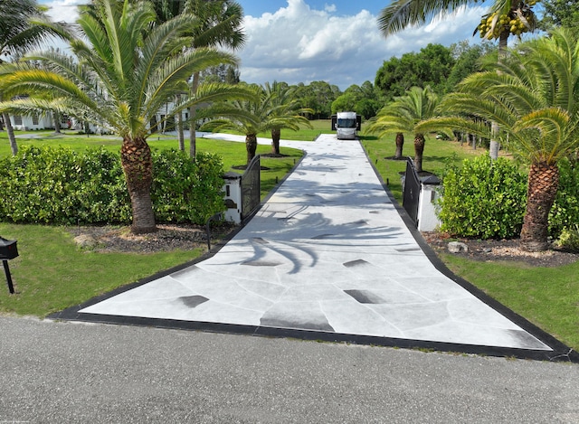 19361 W Sycamore Dr, The Acreage, FL 33470 - view of home's community featuring a yard and driveway