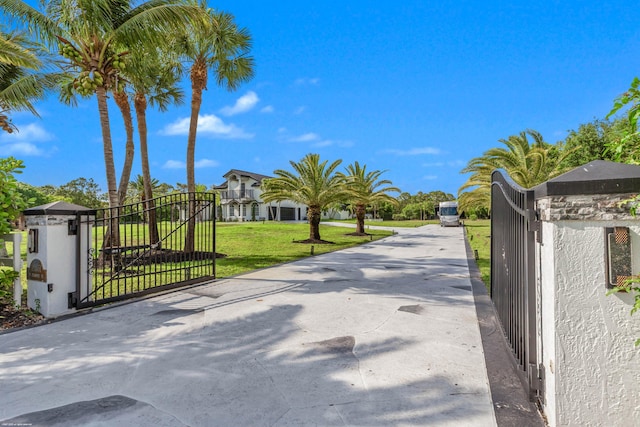 19361 W Sycamore Dr, The Acreage, FL 33470 - view of street with driveway, a gated entry, and a gate