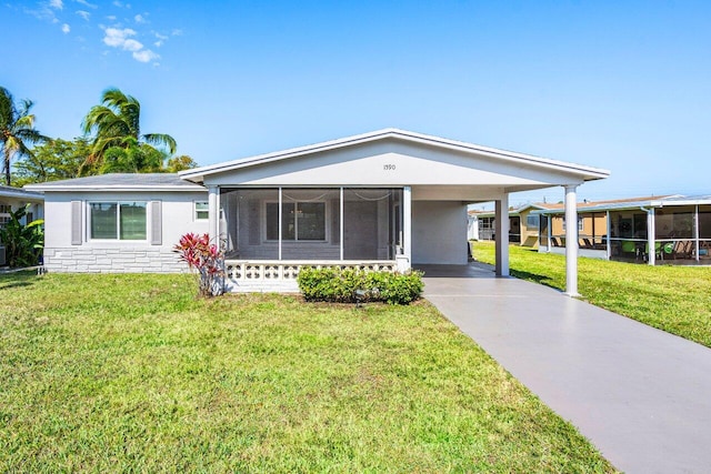 1590 NW 70th Ter, Margate, FL 33063 - ranch-style house with a sunroom, driveway, an attached carport, and a front lawn