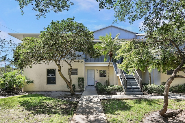 6551 SE Federal Hwy Unit 203, Stuart, FL 34997 - view of front of home featuring stucco siding and stairs
