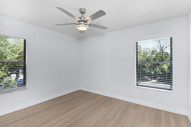 6551 SE Federal Hwy Unit 203, Stuart, FL 34997 - spare room featuring light wood-style flooring, baseboards, and a healthy amount of sunlight