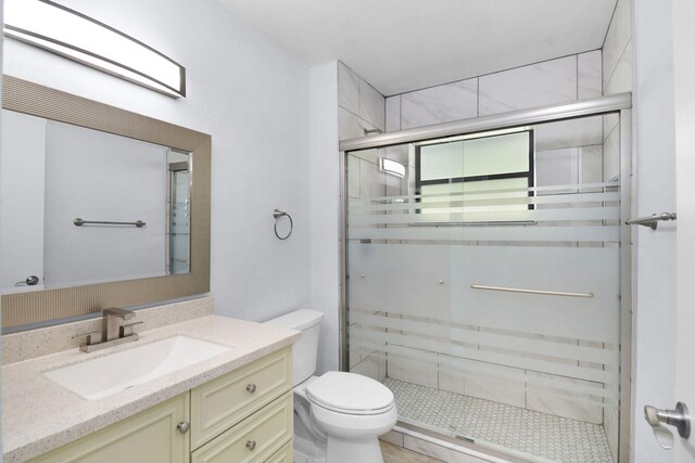 6551 SE Federal Hwy Unit 203, Stuart, FL 34997 - full bathroom with a shower stall, vanity, and toilet