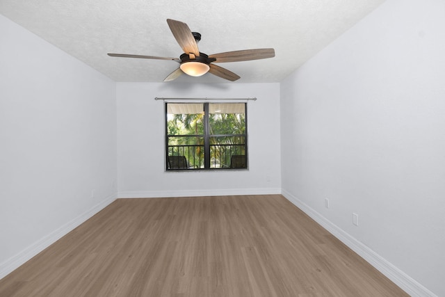 6551 SE Federal Hwy Unit 203, Stuart, FL 34997 - unfurnished room with a textured ceiling, wood finished floors, ceiling fan, and baseboards