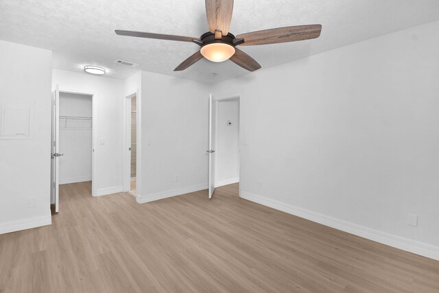 6551 SE Federal Hwy Unit 203, Stuart, FL 34997 - unfurnished bedroom featuring a closet, baseboards, a walk in closet, light wood-style floors, and visible vents