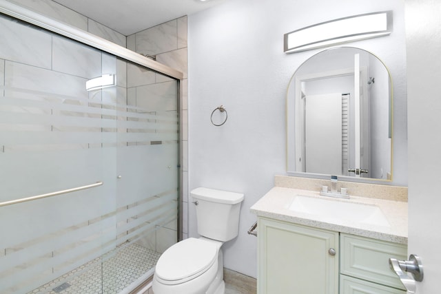 6551 SE Federal Hwy Unit 203, Stuart, FL 34997 - bathroom featuring toilet, a shower stall, and vanity