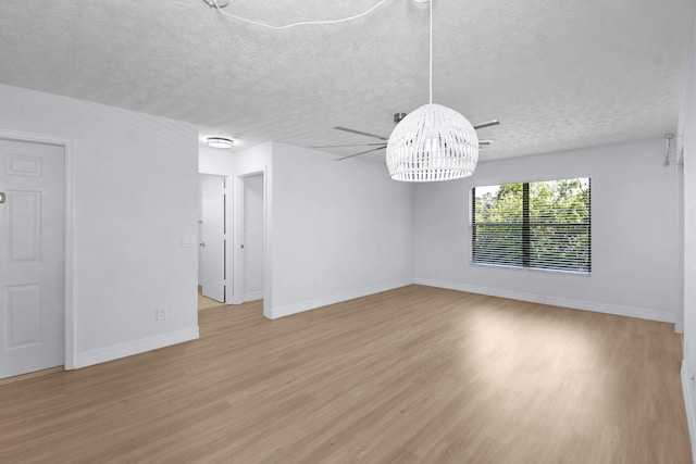 6551 SE Federal Hwy Unit 203, Stuart, FL 34997 - interior space featuring baseboards, light wood finished floors, and a textured ceiling