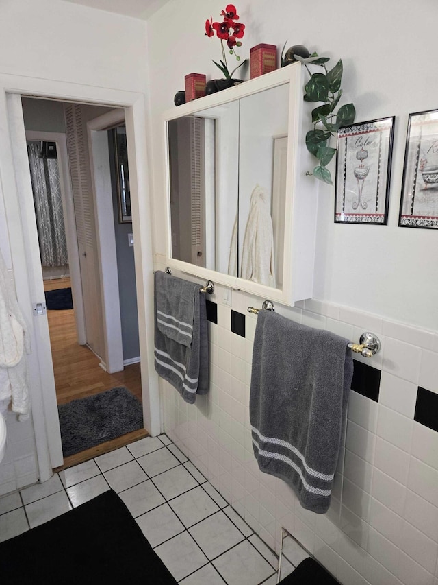2970 E Ashley Dr E Unit B, West Palm Beach, FL 33415 - bathroom with tile patterned flooring and tile walls