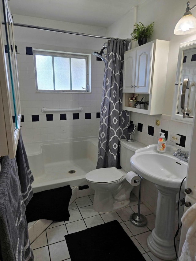 2970 E Ashley Dr E Unit B, West Palm Beach, FL 33415 - full bathroom featuring a shower stall, tile patterned floors, toilet, decorative backsplash, and tile walls
