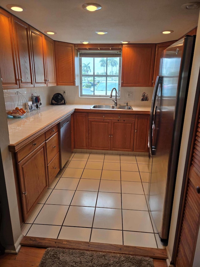 2970 E Ashley Dr E Unit B, West Palm Beach, FL 33415 - kitchen with a sink, appliances with stainless steel finishes, light countertops, brown cabinets, and recessed lighting