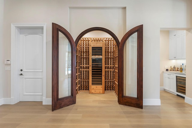 251 W Coconut Palm Rd, Boca Raton, FL 33432 - wine room featuring light wood-style floors, wine cooler, and bar area