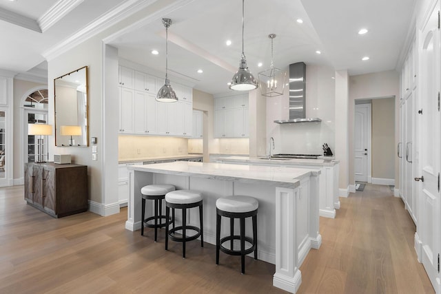 251 W Coconut Palm Rd, Boca Raton, FL 33432 - kitchen featuring wall chimney range hood, a large island with sink, a sink, and light wood-type flooring