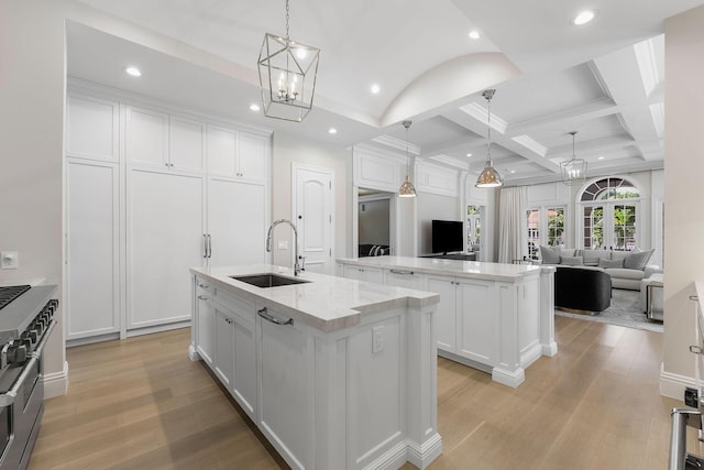 251 W Coconut Palm Rd, Boca Raton, FL 33432 - kitchen featuring a sink, a center island with sink, light wood finished floors, and a chandelier