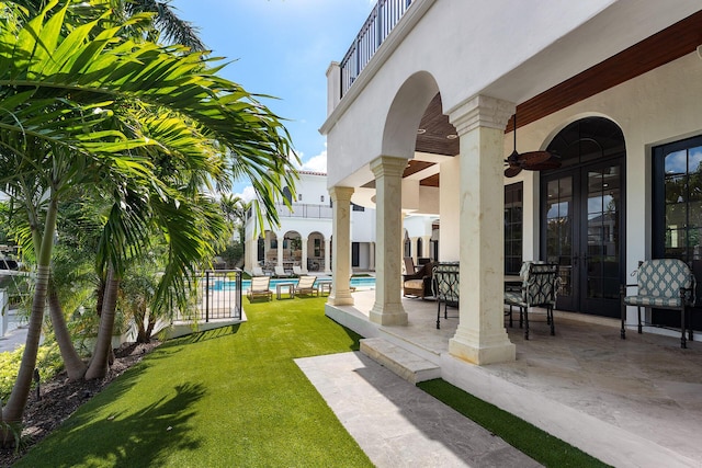 251 W Coconut Palm Rd, Boca Raton, FL 33432 - view of patio / terrace featuring ceiling fan, french doors, an outdoor pool, and a balcony