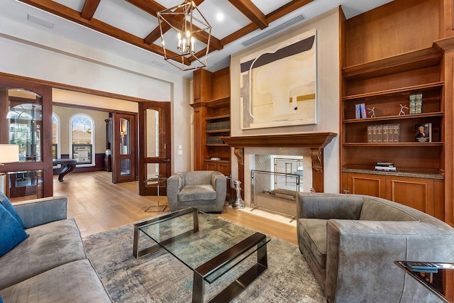 251 W Coconut Palm Rd, Boca Raton, FL 33432 - living area with visible vents, beamed ceiling, coffered ceiling, light wood-style flooring, and a premium fireplace
