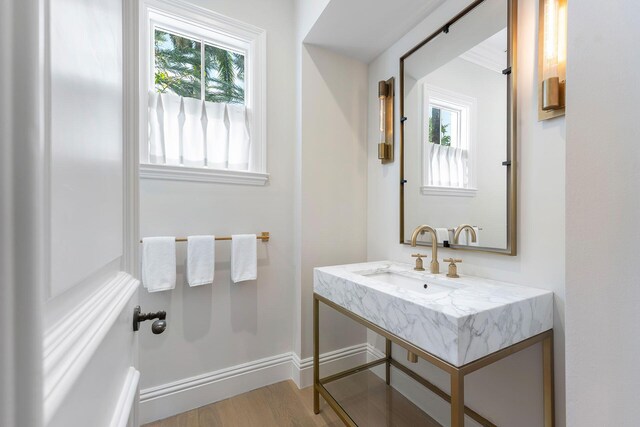 251 W Coconut Palm Rd, Boca Raton, FL 33432 - bathroom with vanity, baseboards, and wood finished floors