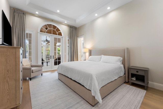 251 W Coconut Palm Rd, Boca Raton, FL 33432 - bedroom featuring access to exterior, french doors, recessed lighting, wood finished floors, and a tray ceiling