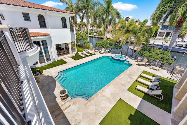 251 W Coconut Palm Rd, Boca Raton, FL 33432 - view of pool with a patio, a water view, a pool with connected hot tub, and fence