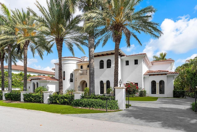 251 W Coconut Palm Rd, Boca Raton, FL 33432 - view of front facade featuring stucco siding, a tiled roof, and fence