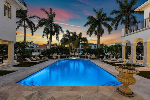 251 W Coconut Palm Rd, Boca Raton, FL 33432 - pool at dusk featuring a patio and a pool with connected hot tub