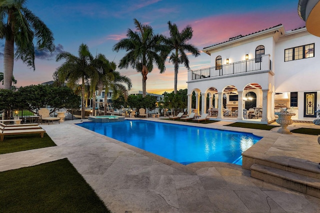 251 W Coconut Palm Rd, Boca Raton, FL 33432 - pool at dusk featuring a patio area and a pool with connected hot tub