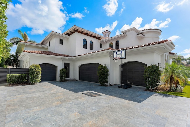 251 W Coconut Palm Rd, Boca Raton, FL 33432 - mediterranean / spanish house featuring a tiled roof, stucco siding, a chimney, and decorative driveway