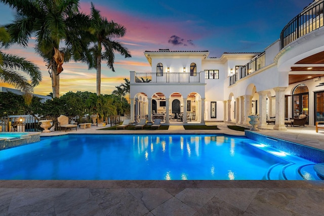 251 W Coconut Palm Rd, Boca Raton, FL 33432 - pool at dusk with a patio and a pool with connected hot tub