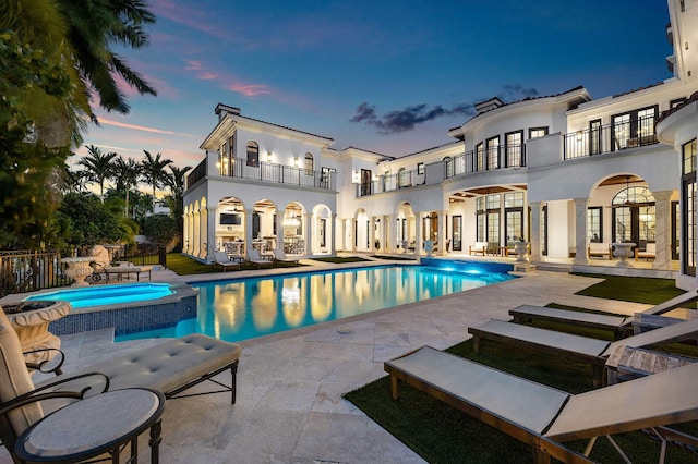 251 W Coconut Palm Rd, Boca Raton, FL 33432 - rear view of house featuring a pool with connected hot tub, a balcony, a patio area, and stucco siding