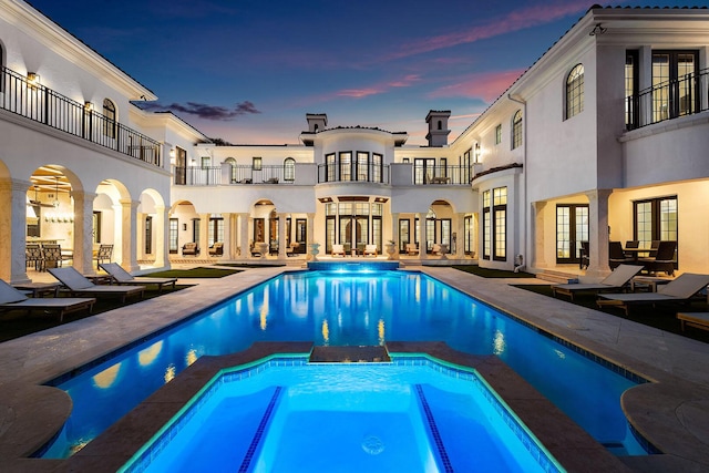 251 W Coconut Palm Rd, Boca Raton, FL 33432 - view of pool with a patio area, a pool with connected hot tub, and french doors