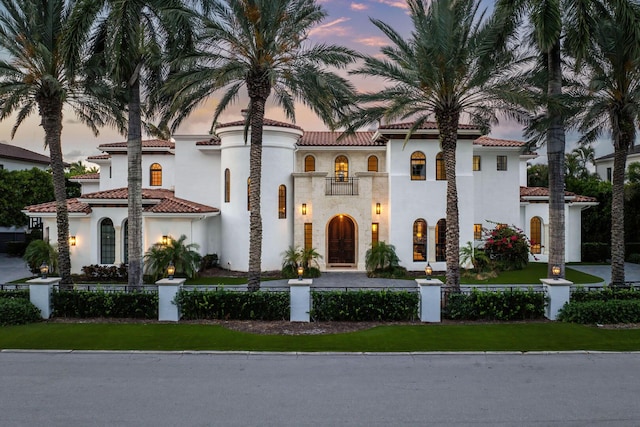 251 W Coconut Palm Rd, Boca Raton, FL 33432 - mediterranean / spanish-style home with a fenced front yard, a tile roof, and stucco siding