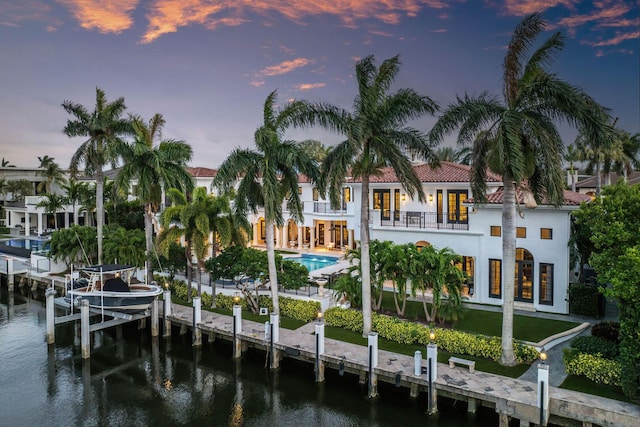 251 W Coconut Palm Rd, Boca Raton, FL 33432 - rear view of property featuring boat lift, a balcony, a patio, an outdoor pool, and a water view