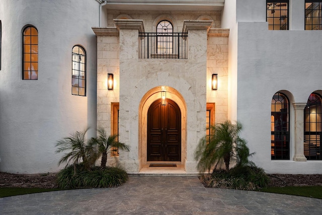 251 W Coconut Palm Rd, Boca Raton, FL 33432 - entrance to property with stucco siding, stone siding, and a balcony