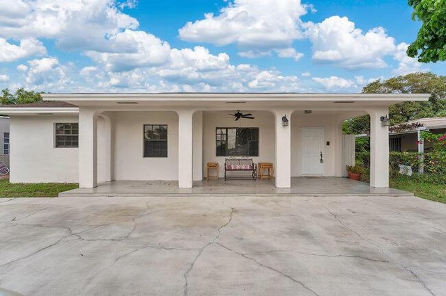 3682 W 2nd Ave, Hialeah, FL 33012 - view of front of home featuring a ceiling fan, stucco siding, covered porch, and driveway