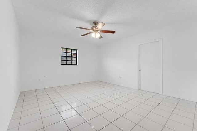 3682 W 2nd Ave, Hialeah, FL 33012 - spare room with a ceiling fan, a textured ceiling, and light tile patterned flooring