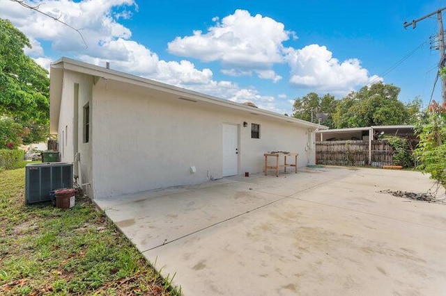 3682 W 2nd Ave, Hialeah, FL 33012 - back of house featuring central AC, stucco siding, and a patio