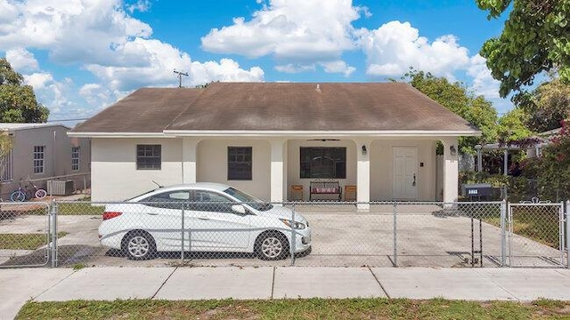 3682 W 2nd Ave, Hialeah, FL 33012 - view of front of home featuring stucco siding, a fenced front yard, covered porch, and a gate