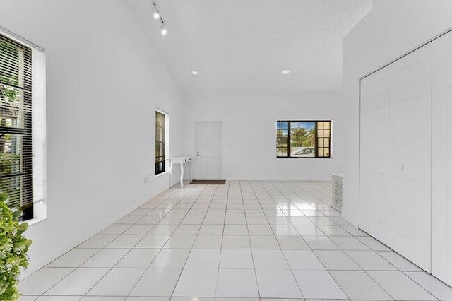 3682 W 2nd Ave, Hialeah, FL 33012 - empty room featuring high vaulted ceiling and light tile patterned floors