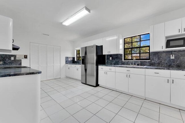 3682 W 2nd Ave, Hialeah, FL 33012 - kitchen featuring stainless steel appliances, a sink, decorative backsplash, and white cabinets