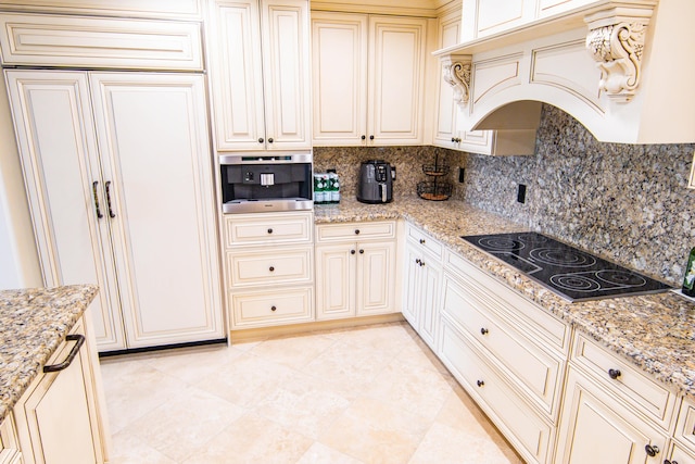 200 E Palmetto Park Rd Unit 503, Boca Raton, FL 33432 - kitchen with black electric cooktop, light stone countertops, decorative backsplash, and custom range hood