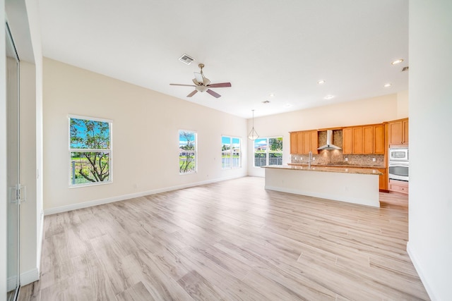 unfurnished living room featuring light wood-type flooring, baseboards, visible vents, recessed lighting, and ceiling fan